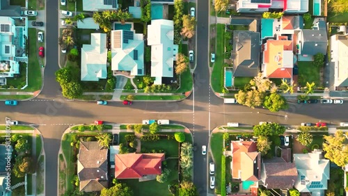 A view above houses and rod traffic with tropical palm trees in Darwin city Australia. Aerial view of a residential neighborhood. photo