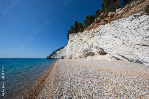 Spiaggia di Vignanotica pebble beach under a white cliff, Mattinata, Gargano promontory, Puglia photo
