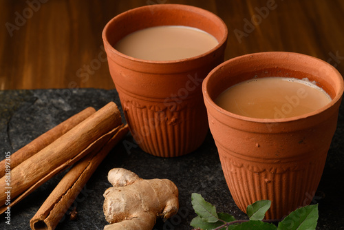 Earthen tea cup or Chai in kulhad with Ginger, Cardamom  Cinnamon tulsi photo