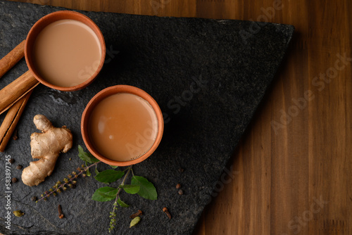 Earthen tea cup or Chai in kulhad with Ginger, Cardamom  Cinnamon tulsi photo