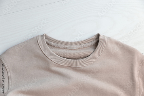 MOKITUP: Lifestyle Isolated Closeup Crewneck Sweatshirt Neck Collar Mockup Against Woodgrain photo