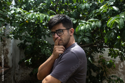 Young man with glasses looking mysterious