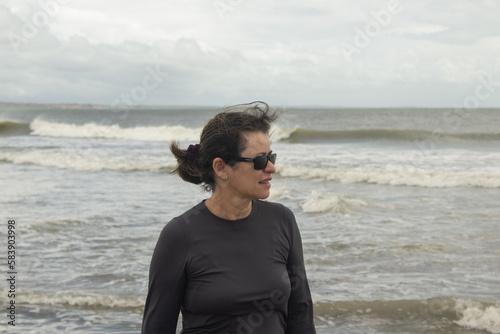 Woman in sunglasses on the beach
