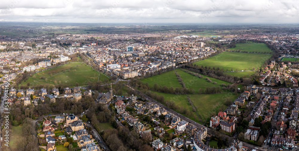 Aerial townscape view of Harrogate with traffic and The Stray public park