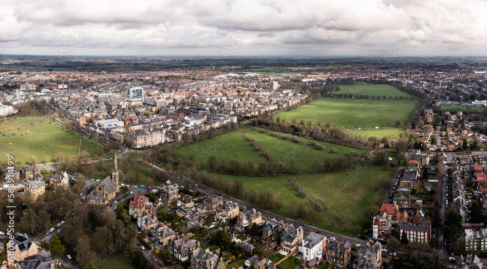 Aerial townscape view of Harrogate with traffic and The Stray public park