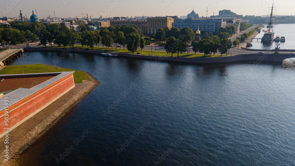 Aerial view of the Peter-Pavel's Fortress, Church next to bridges and Sailing ship on the river and water channel in the historical centre of city of St. Petersburg at clear summer sunrise