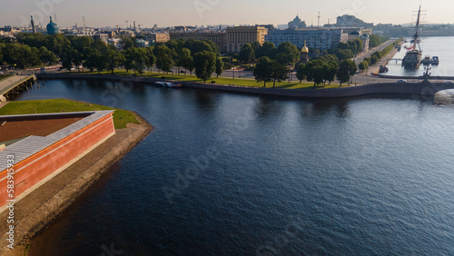 Aerial view of the Peter-Pavel's Fortress, Church next to bridges and Sailing ship on the river and water channel in the historical centre of city of St. Petersburg at clear summer sunrise