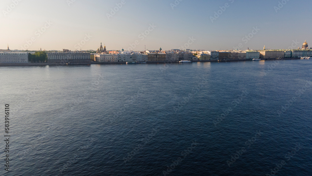 Aerial view above water of the Peter-Pavel's Fortress next to bridges on the river and water channel in the historical centre of city of St. Petersburg at sunny summer sunrise
