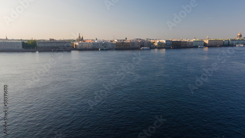 Aerial view above water of the Peter-Pavel's Fortress next to bridges on the river and water channel in the historical centre of city of St. Petersburg at sunny summer sunrise 