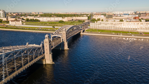 Aerial view of the car Bolsheokhtinsky bridge above the river in the historical and at same time modern centre of city of St. Petersburg at sunny summer sunset