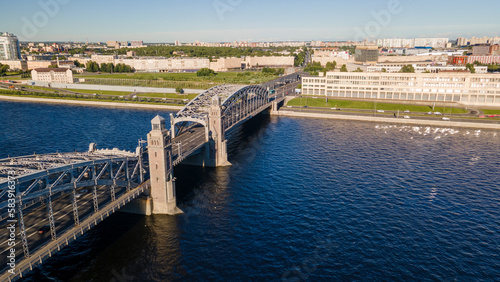 Aerial above view of the car Bolsheokhtinsky bridge above the river and water channel in the historical and at same time modern centre of city of St. Petersburg at sunny summer sunset