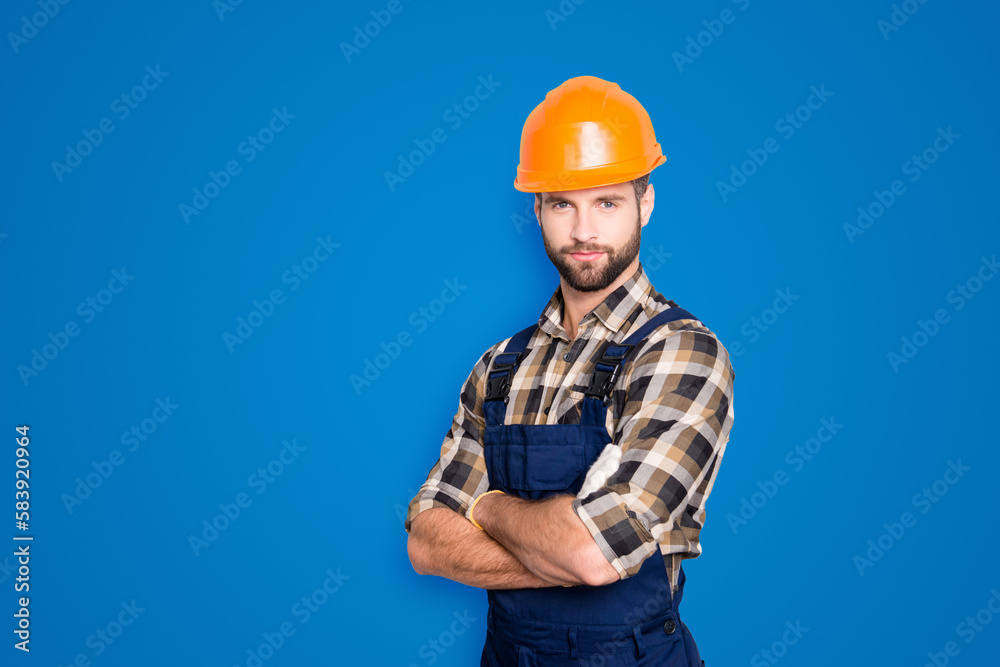 Portrait with copyspace of attractive handsome repairer in shirt and overall looking at camera isolated on grey background, having arms crossed, isolated on grey background Portrait with copyspace of attractive handsome repairer in shirt and overall looking at camera isolated on grey background, having arms crossed, isolated on grey background