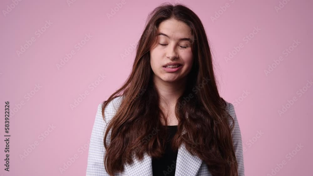 4k video of one girl who grimacing over pink background. 4k video of one girl who grimacing over pink background.