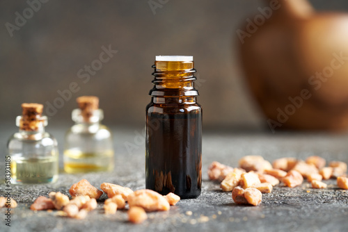 A dropper bottle of essential oil with styrax resin photo
