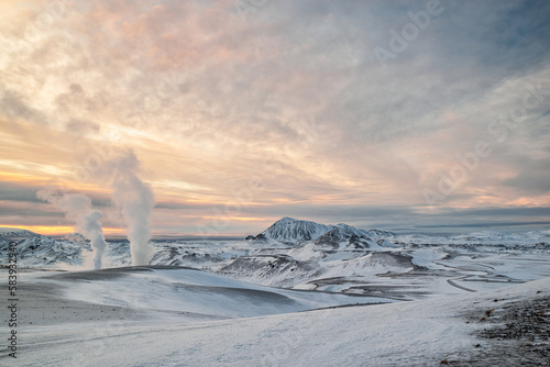 Steaming fumaroles from a geothermal spring at Hverir near Myvatn lake at sunrise, Iceland photo