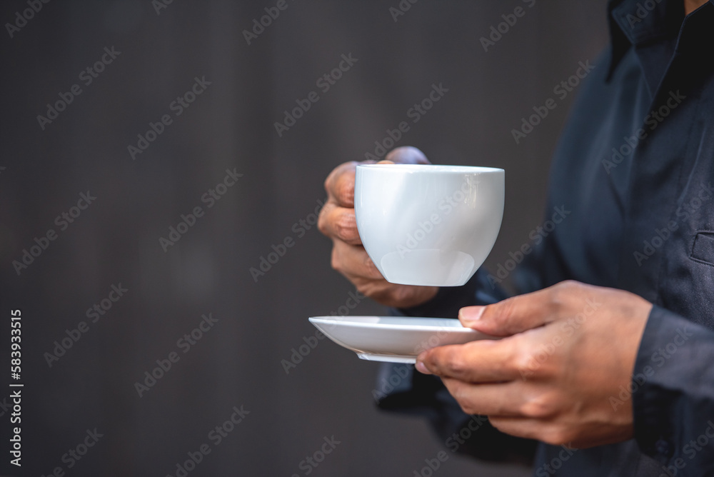 Asian man holding hot coffee in paper mug cup to sniff smell of espresso in morning sunlight. man carry coffee break to sniff fragrant smell the aroma of coffee and work. Asian man holding hot coffee in paper mug cup to sniff smell of espresso in morning sunlight. man carry coffee break to sniff fragrant smell the aroma of coffee and work.