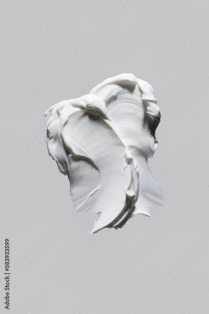 White moisturising cream swatch. Face lotion or mask texture. Butter cream macro. Skin care sample. Cosmetic smudge on grey background closeup. Beauty product. Sunscreen stoke. Top view. White moisturising cream swatch. Face lotion or mask texture. Butter cream macro. Skin care sample. Cosmetic smudge on grey background closeup. Beauty product. Sunscreen stoke. Top view.