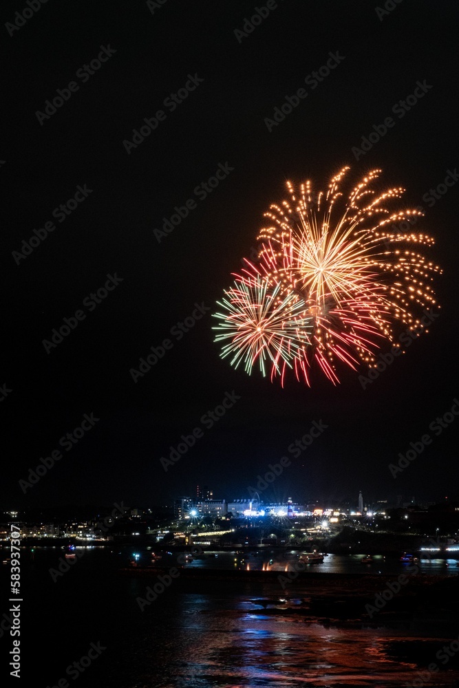 Vertical shot of Fireworks exploding over the illuminated city of Plymouth, Cornwall. Vertical shot of Fireworks exploding over the illuminated city of Plymouth, Cornwall.