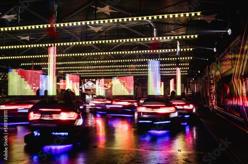Long exposure shot of glowing bumper cars ride at the annual street fair in St Giles, Oxford © Pez Photography/Wirestock Creators