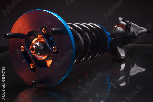 auto suspension tuning coilovers shock absorbers and springs blue for a sports drift car on a dark background photo