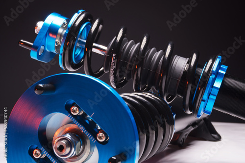 auto suspension tuning coilovers shock absorbers and springs blue for a sports drift car on a dark background