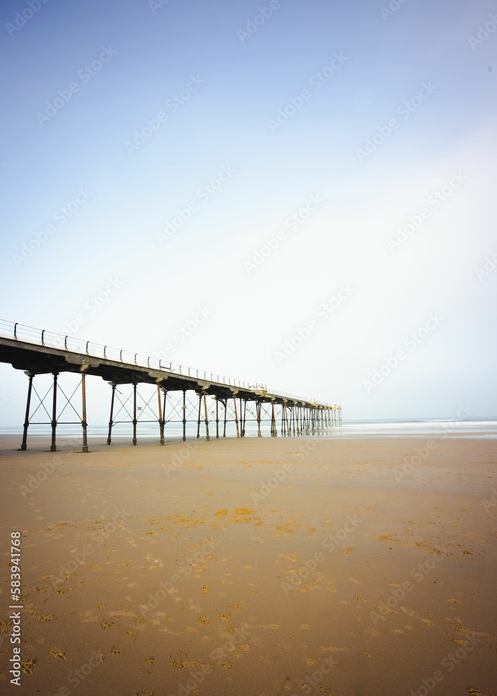 Vertical shot of the pier at the seaside town of Saltburn-by-the-Sea on a misty day, North Yorkshire