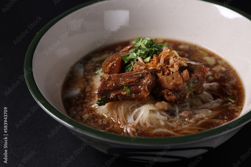 Braised pork noodles Thai street food isolated in black background Braised pork noodles Thai street food isolated in black background