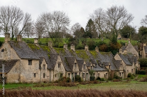 Fototapeta Row of the historic quintessential Cotswold cottages in Bibury, Gloucestershire,