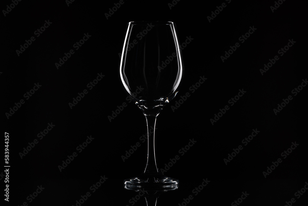 Wine glass on the black background. White contour on the black. 