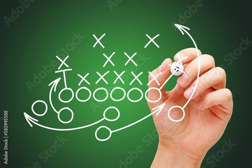 Coach Drawing American Football Game Playbook In Locker Room