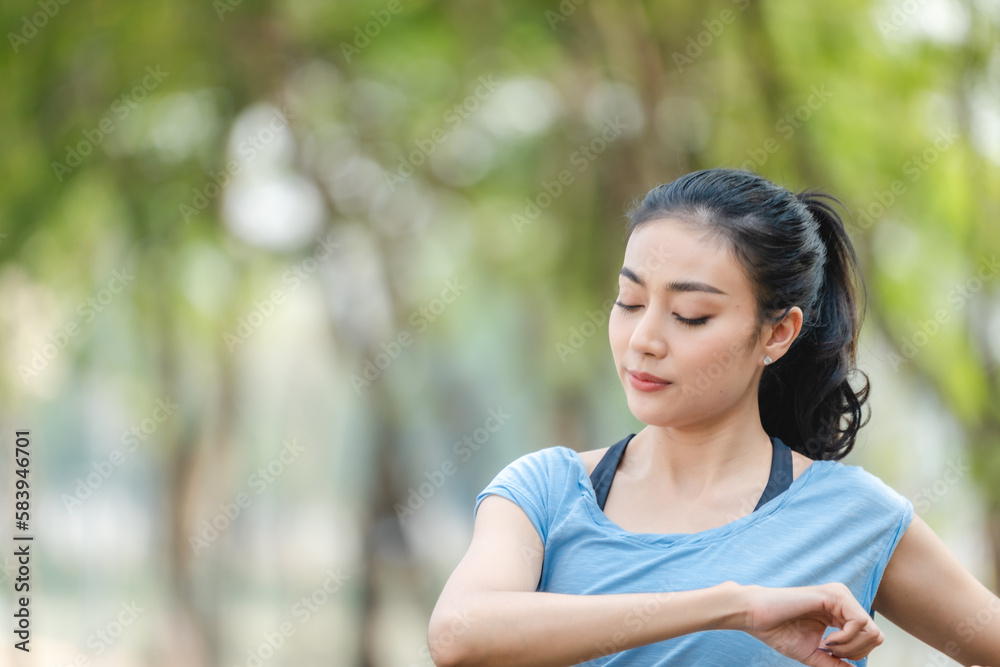 Asian woman stretching body and neck after jogging exercise at park in the city. Attractive athlete girl in sportswear enjoy outdoor lifestyle sport training fitness running workout in morning summer Asian woman stretching body and neck after jogging exercise at park in the city. Attractive athlete girl in sportswear enjoy outdoor lifestyle sport training fitness running workout in morning summer