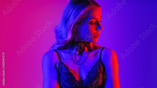 Sensual neon close up portrait of young woman. Studio shot