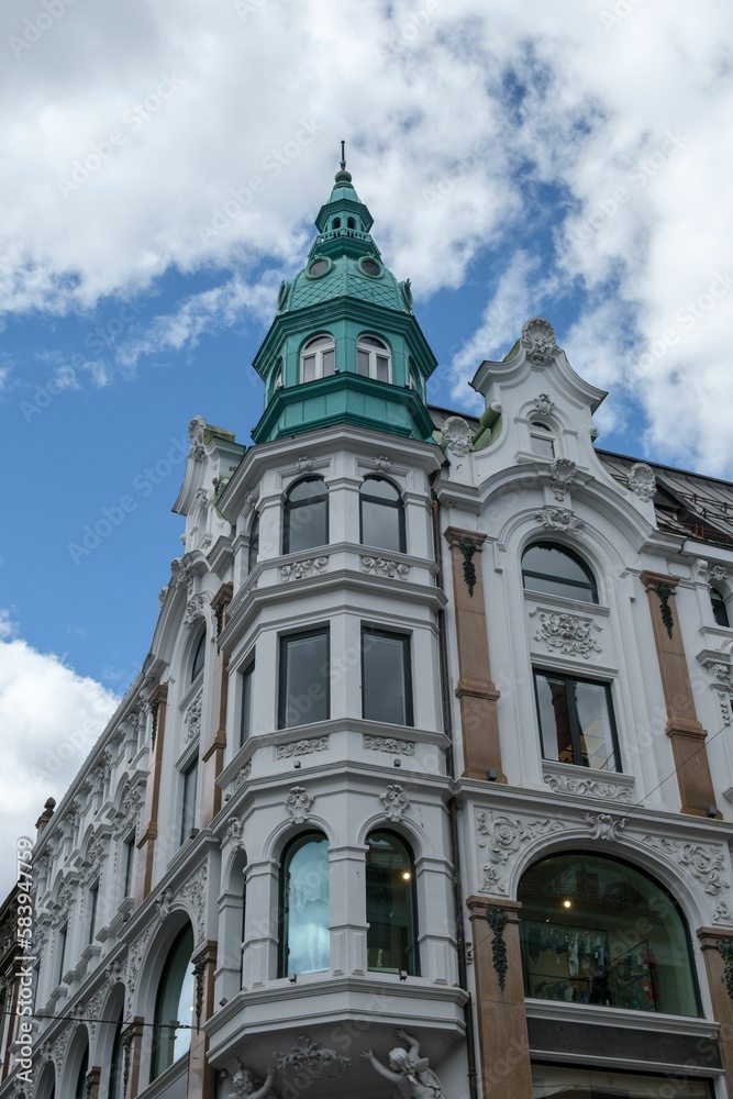Vertical low-angle shot of a historic building in the center of Oslo under the clouds