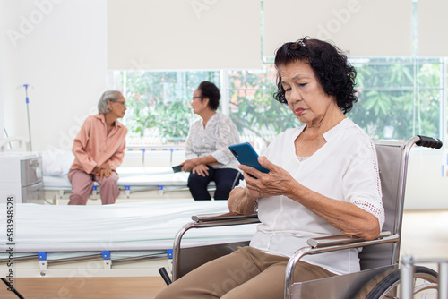 nursing home care concept. Elderly Woman Using A Mobile Telephone. looking at camera