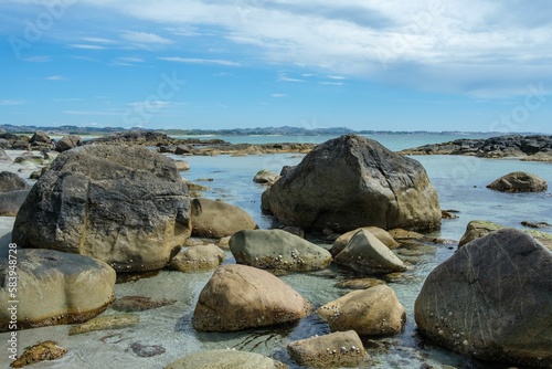 Beautiful view of big rocks on the coastline under the peaceful sky © 35mmfs/Wirestock Creators