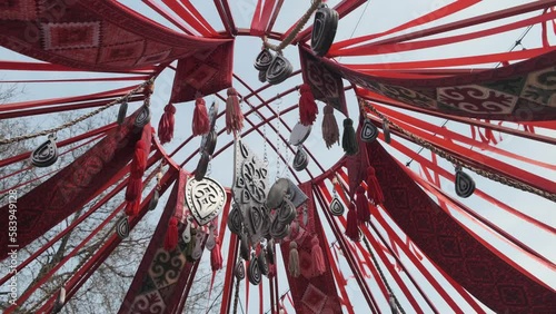 Wide shot of decoration elements of asian holiday Nauryz are swaying in the wind