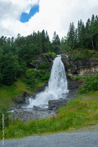 Vertical shot of the flowing Steindalsfossen waterfall in the mountains of Norway