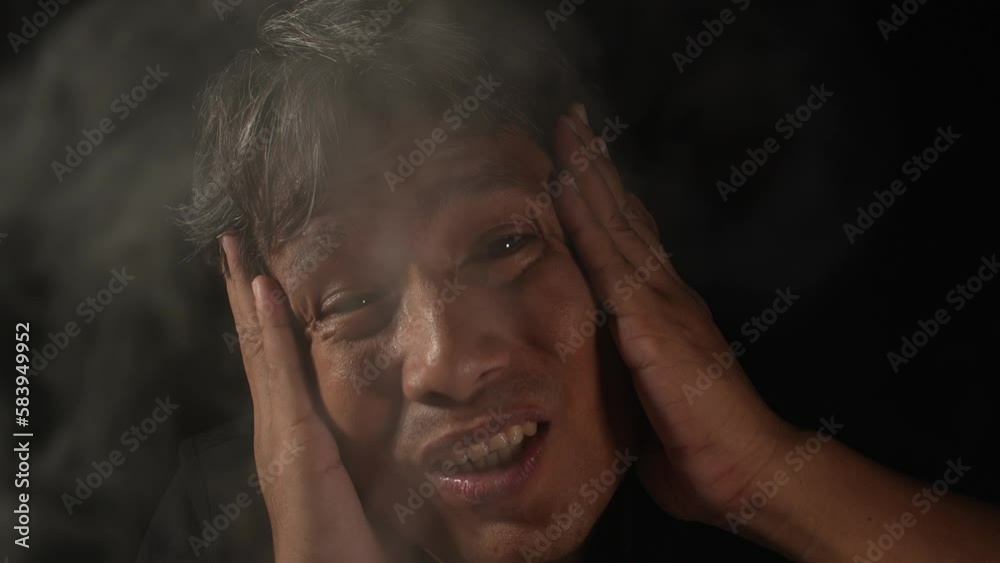 Smoke cigarette air pollution with health and environmental impacts concept. Asian man be scared smog pollution. Smoke cigarette air pollution with health and environmental impacts concept. Asian man be scared smog pollution.