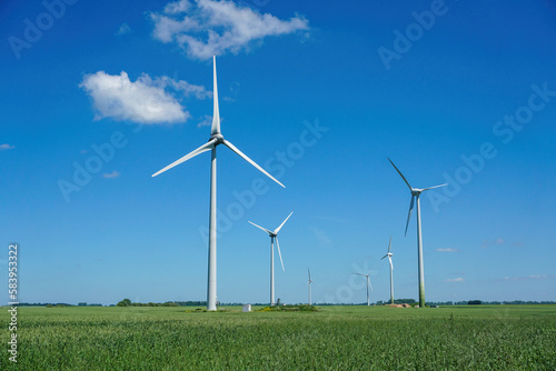 Wind turbines windmill energy farm. Summer time.