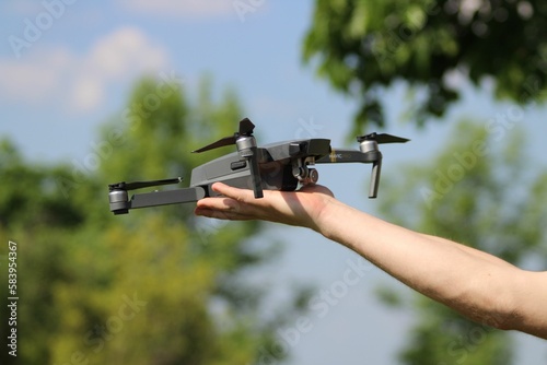 Human hand holding drone