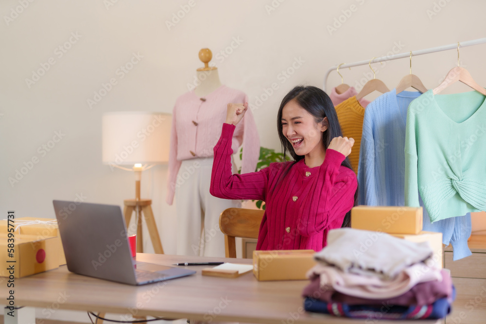 Happy Asian woman. Online small business owner who is successful and makes a lot of sale.