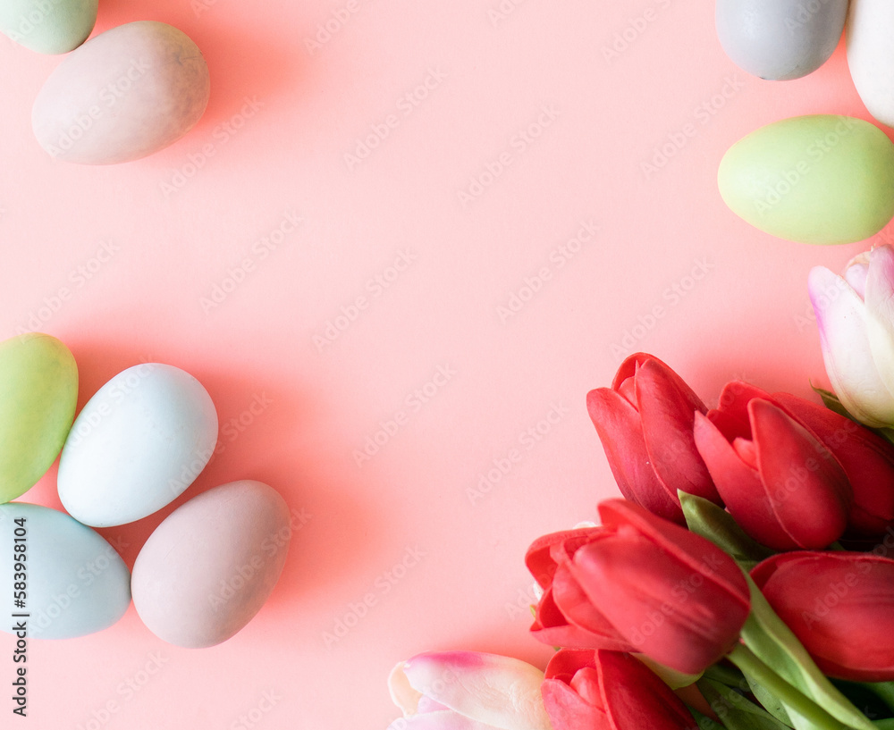 Easter eggs and tulips on light green background