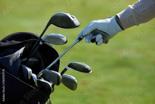 Schilderij op canvas Closeup of unrecognizable golf player choosing club and taking out of golf bag a