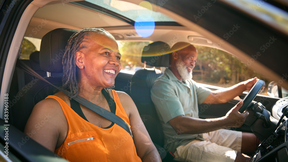 Senior Couple Enjoying Summer Day Trip Out Driving In Car Together Senior Couple Enjoying Summer Day Trip Out Driving In Car Together