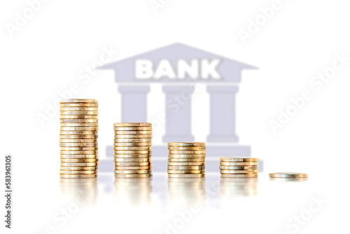 Piles of money coins with a bank icon in the background. Concept of banking crisis