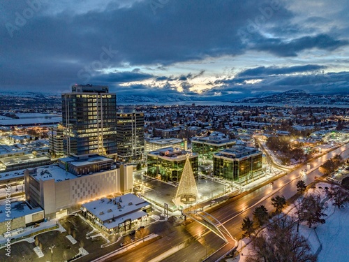 Drone shot of buildings and a light Christmas tree in Kelowna, British Columbia, Canada