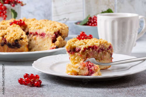 Homemade cake with berries on gray background. Yogurt pie with fresh red currant.