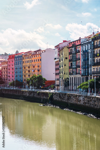 Colorful architecture and the Nervion river in Bilbao city. Enjoying a nice vacation in the Basque Country, Spain