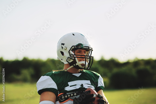 Quarterback holding a football during a practice photo