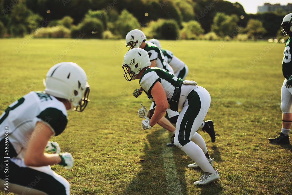 American football team doing practice drills on a sports field American football team doing practice drills on a sports field